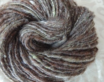 Pretty Wolf handspun Aran weight art yarn with green and sparkles, 88 yards