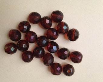 Vintage glass 10mm faceted round bead. This beauty is semi matte terra cotta in color.