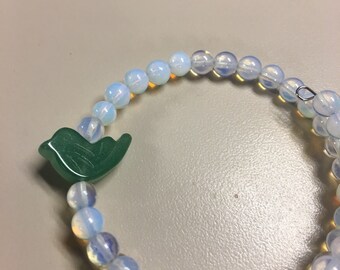 White beaded bracelet with bird