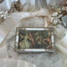 vintage mele courting scene footed small jewel box, white with gold tone metal frame, roses. hinged lid, red velveteen interior