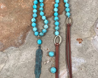 Patina bronze feather pendant on a robins egg blue howlite and leather necklace with matching earrings