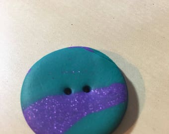 Purple and green polymer clay button