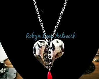 To Mend A Broken Heart Necklace with Silver Heart "Sewn" Together with Black Links and Pearl Blood Drop