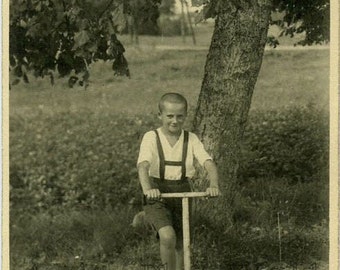 Boy on scooter antique toy photo
