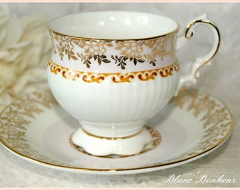 Elizabethan Staffordshire, England: Pedestal pink and gold tea cup & saucer
