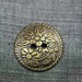 Bronze metal button with flower motif