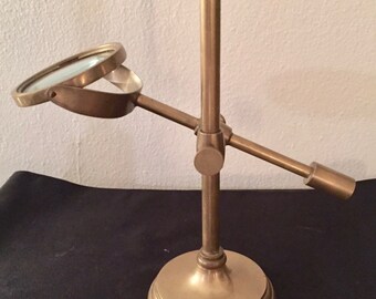 Brass adjustable table top magnifying glass.