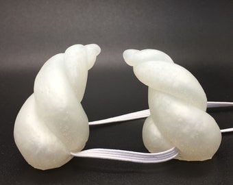 Small pearl white curved horns