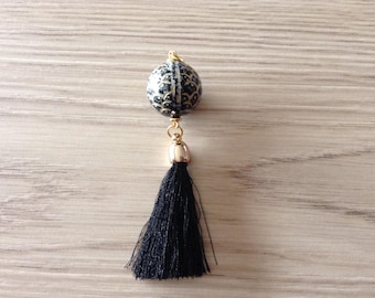 Bead patterns scales and black tassel pendant