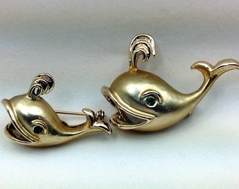 A pair of Vintage whale pins.