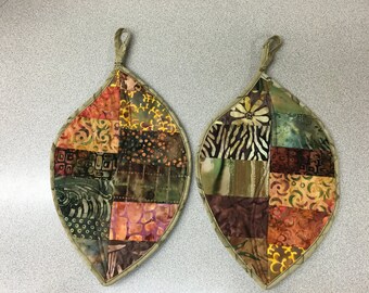 This is a pair of handmade leaf shaped potholders