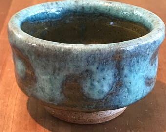 Hand thrown footed stoneware teacup in blue/green glaze