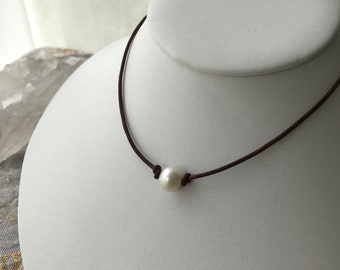 Single freshwater pearl on leather