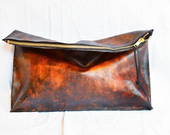 Fold over distressed leather clutch