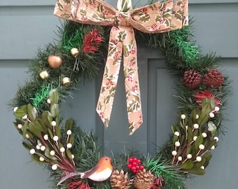 Winter Christmas Wreath with pinecones ,a large burlap holly and red berry bow, mistletoe, a robin, bells, berries and extra glitter!