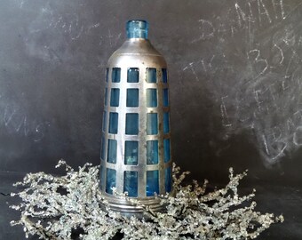 Blue glass bottle with chrome cage