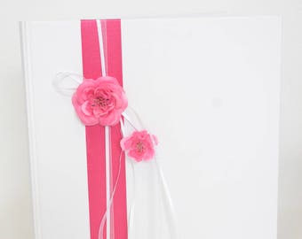White guest book and ribbons, flowers