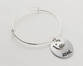 SOAR hand stamped metal & silver bird charm bangle