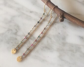 Rosario Topazes and medal earrings.