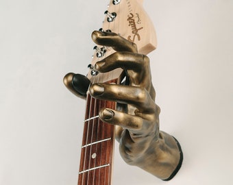 Antique Finish- Brass hand guitar hanger - Left. Unique guitar accessory and wall mounted decor.