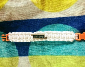 Para-cord bracelet with metal Believe label