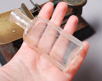 Antique miniature clear glass bottle, medical or laboratory bottle.