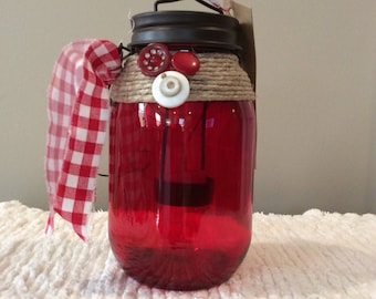 Red glass lantern jar-red gingham-ribbon-brown metal lid-star cutout-hanging lantern-candle-jute-buttons-white-led light-vintage-primitive
