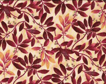 Tissu coton Branchages d'autonne ocres et rouges foncés sur fond beige.