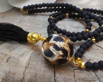 Long beaded black tassel necklace. Animal print necklace. Boho necklace. Long black beaded tassel necklace with animal print bead.