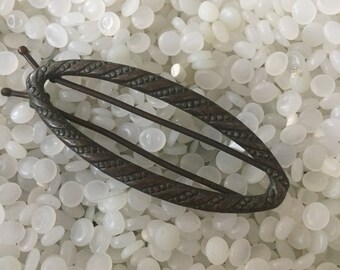 Vintage barrette pressed metal oval, with twist details,