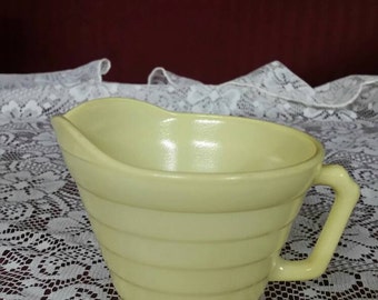 Platonite milk glass yellow pitcher. Hazel atlas.