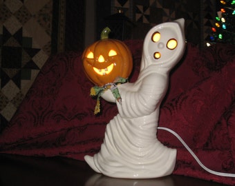 Halloween, Ceramic Running ghost carrying a pumpkin hand painted by Joan Davis, 12" tall