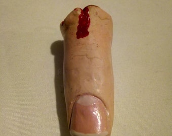 Severed finger pendant