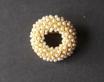 Gold tone circular brooch with lots of tiny pearl beads