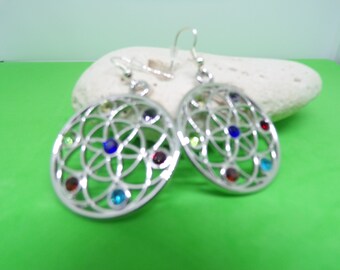 With earrings decorated with Rhinestones