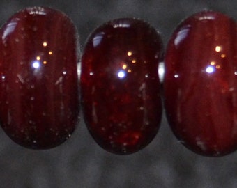Carmine- seven boro lampwork beads. SRA K45