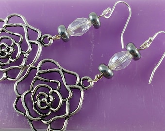Delicate Patina Rose Accented With a Glass Bead In These Drop Earrings