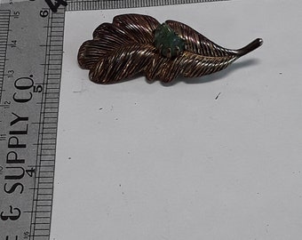 Gold toned leaf pin brooch with green stone used