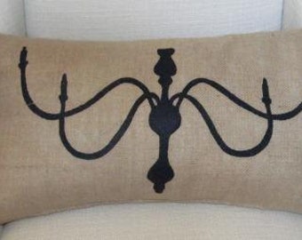 Black chandelier on burlap pillow