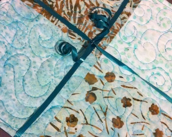 Beautiful pot holders in blues, aquas, teals & tan batiks