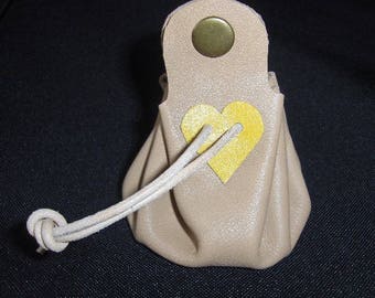Coin purse is off-white leather with yellow heart