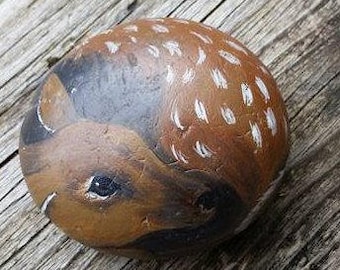 Hand painted baby deer on a beach rock.