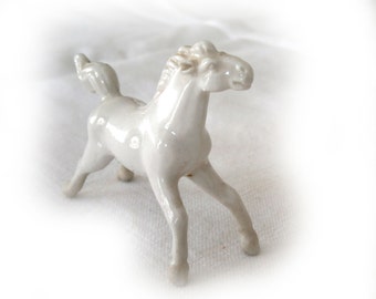 Miniature porcelain horse figurine.