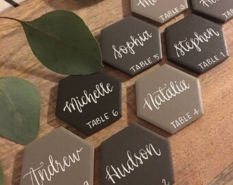 Tile place cards with guests' names in modern calligraphy.