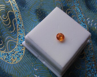 Approximately .65ct 5.5mm Round Mandarin Garnet