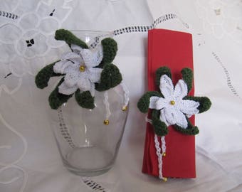 Christmas flowers, white poinsettia, a tie around bottles or napkins