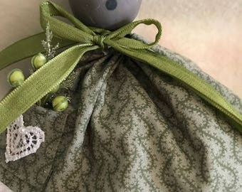 Ms. Mouse Christmas ornament dressed in her green dress, ribbon, and berries. She is also wearing her lace petticoat. She is handmade.