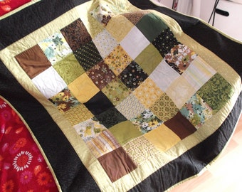 Patchwork quilt using yellow, green, brown and black