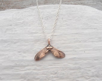 Tiny bronze maple seed necklace