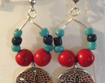 sand dollars with a splash of red
